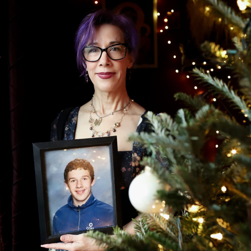 Laura with photograph of her son, Jack, on Solstice 2024.