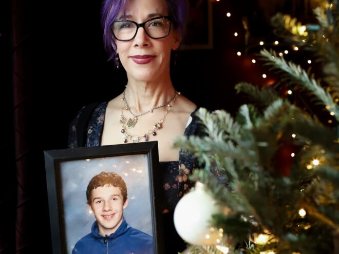 Laura with photograph of her son, Jack, on Solstice 2024.